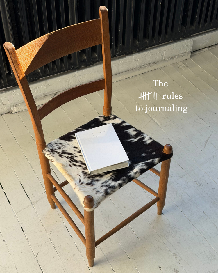 A No Particular Order journal resting on a cowhide chair, with the words The 7 rules to journaling